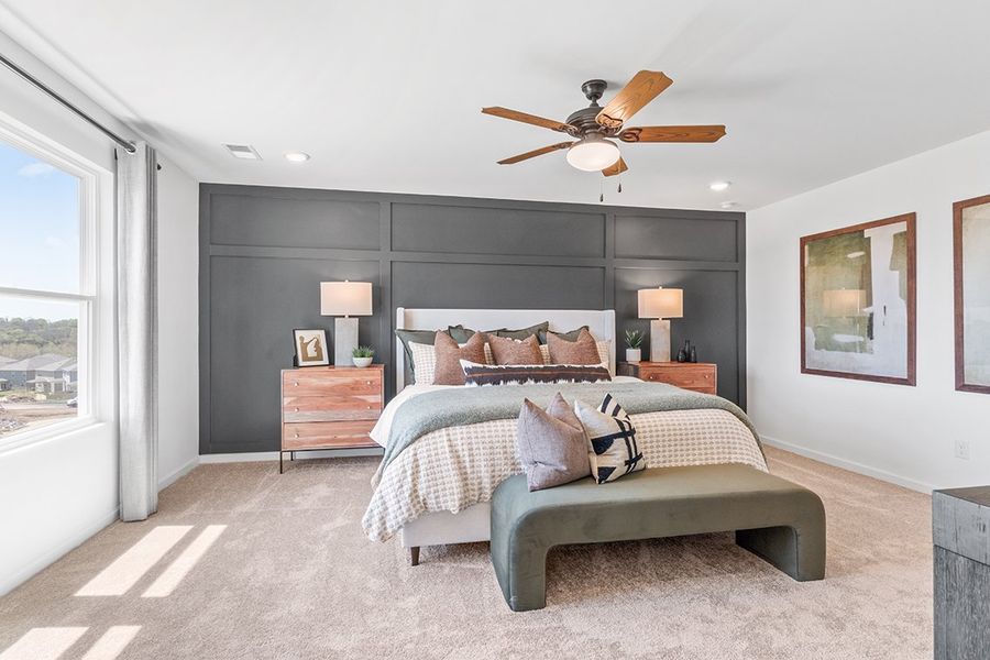 A bedroom with a bed and a fan.
