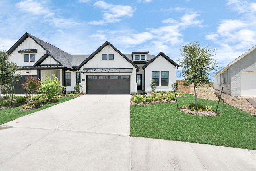 Front exterior of a new home in Bridgeland: Signature Collection, Cypress, TX, highlighting curb appeal (Image 21). Front exterior of a new home in Bridgeland: Signature Collection, Cypress, TX, highlighting curb appeal (Image 21).