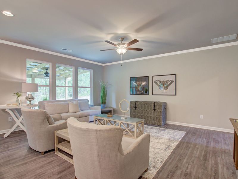 Family room with large windows overlooking the backyard