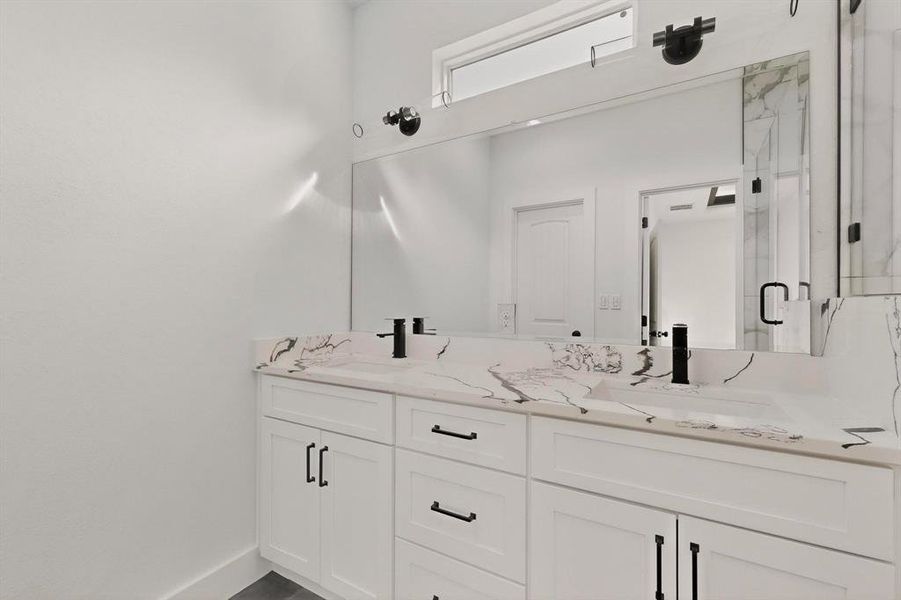 Bathroom with double vanity and a marble finish shower Bathroom with double vanity and a marble finish shower