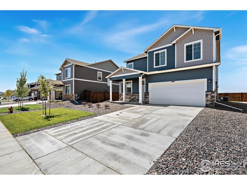 Front exterior of a new home in Vista Meadows, Fort Lupton, CO, highlighting curb appeal (Image 20).