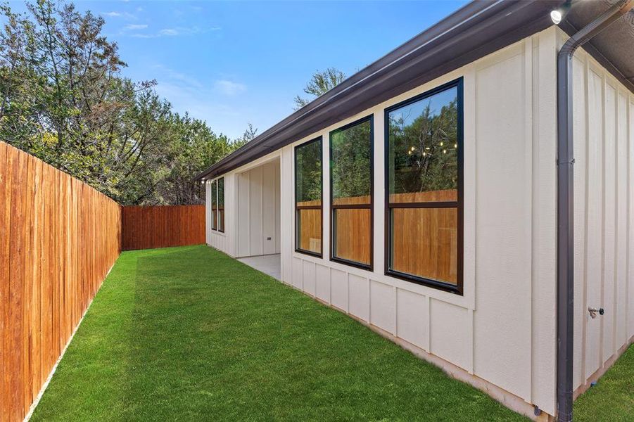 View of side of property with a yard