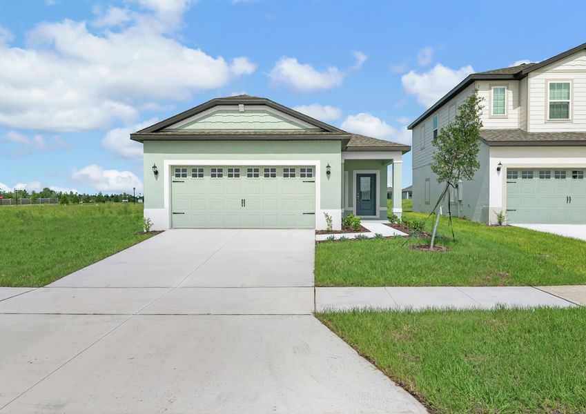 The exterior of the two-car garage Cypress with a sidewalk the leads to the covered porch The exterior of the two-car garage Cypress with a sidewalk the leads to the covered porch