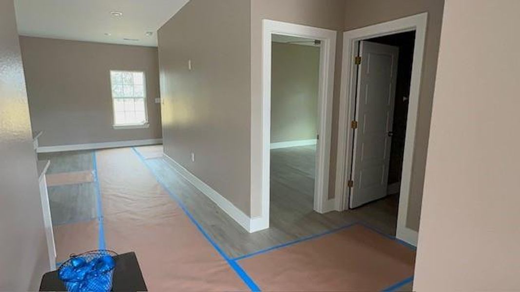 Corridor with baseboards and wood finished floors