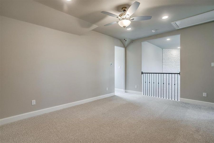 Empty room with ceiling fan and carpet flooring