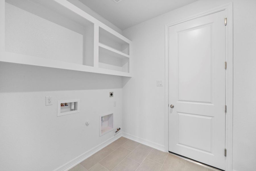 The laundry room layout is carefully planned for optimal workflow with designated areas for washing, drying, and storing.