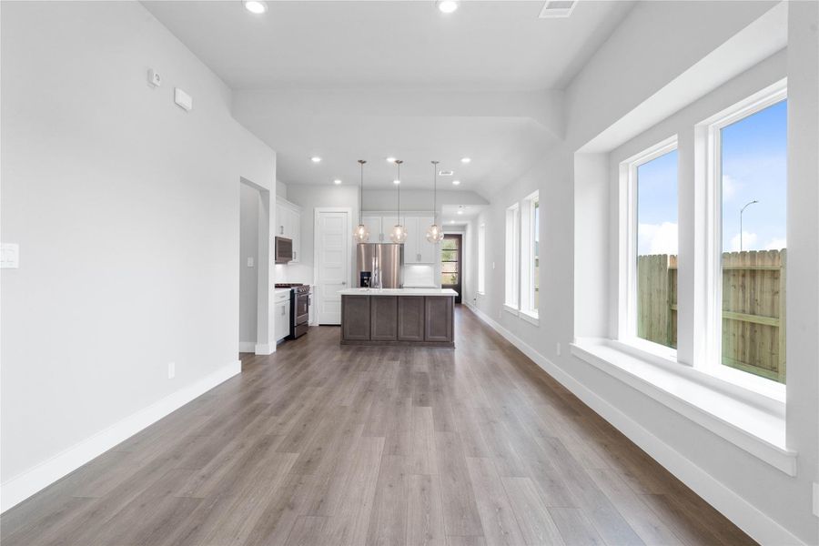 Create lasting memories around the table with family and friends in the dining! It showcases high ceilings, large windows, laminate flooring, and recessed lighting for a warm and welcoming atmosphere. Additionally, the massive, sun-drenched window seat spans the living area, offering a picturesque view and a perfect architectural focal point. Create lasting memories around the table with family and friends in the dining! It showcases high ceilings, large windows, laminate flooring, and recessed lighting for a warm and welcoming atmosphere. Additionally, the massive, sun-drenched window seat spans the living area, offering a picturesque view and a perfect architectural focal point.