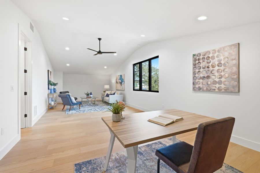 Office area featuring light wood-style flooring, recessed lighting, vaulted ceiling, and ceiling fan