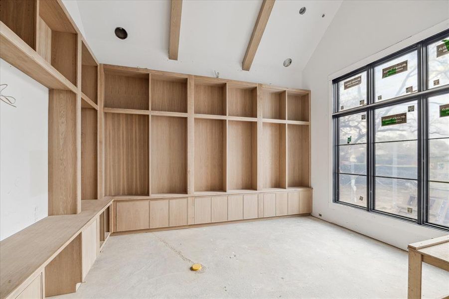 Library on the front of the property with a wall of windows. Plenty of storage and built in shelves.  The room measures 19x16.