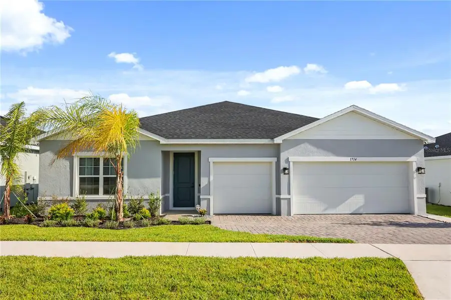 Front exterior of a new home in , Winter Haven, FL, highlighting curb appeal (Image 1). Front exterior of a new home in , Winter Haven, FL, highlighting curb appeal (Image 1).