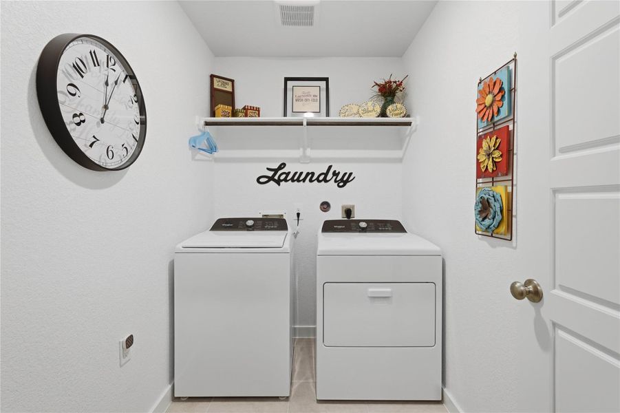 The well-sized utility room offers plenty of space for extra shelving and a spare refrigerator.