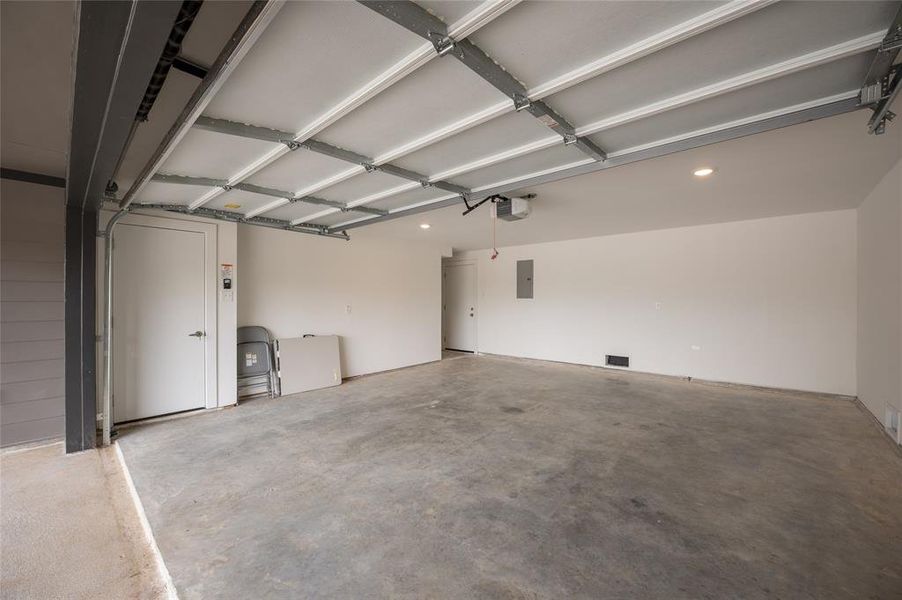 *Representative Photo. This is a spacious, clean two-car garage with a high ceiling, concrete floor.