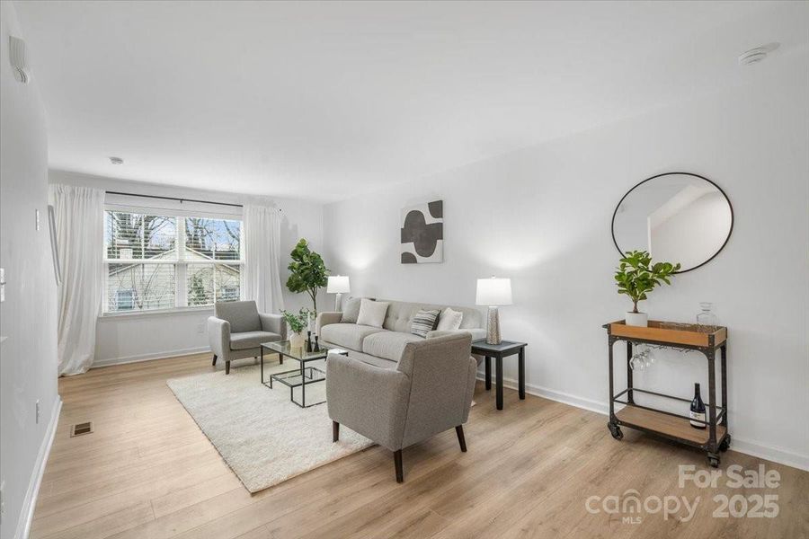 Large front window in the main living area. Most of the year the luscious trees add privacy from your neighbors