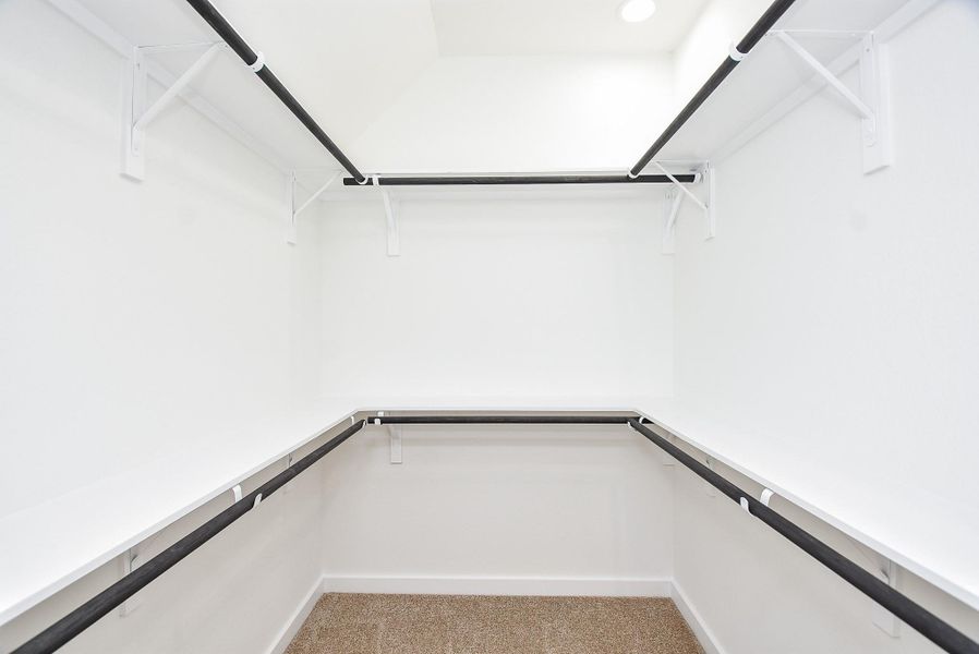 Spacious walk-in closets in bedrooms, offering ample storage with built-in shelving and double hanging rods. Designed for both functionality and organization. Spacious walk-in closets in bedrooms, offering ample storage with built-in shelving and double hanging rods. Designed for both functionality and organization.