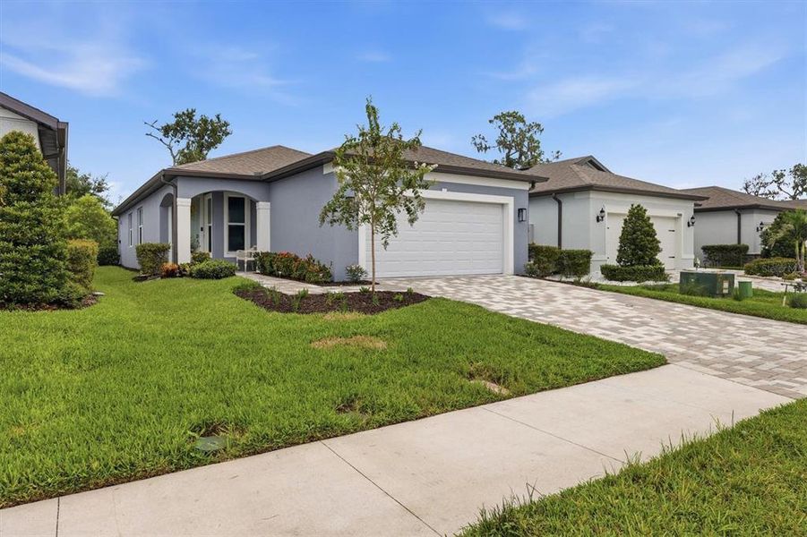 Front exterior of a new home in Del Webb BayView, Parrish, FL, highlighting curb appeal (Image 1). Front exterior of a new home in Del Webb BayView, Parrish, FL, highlighting curb appeal (Image 1).