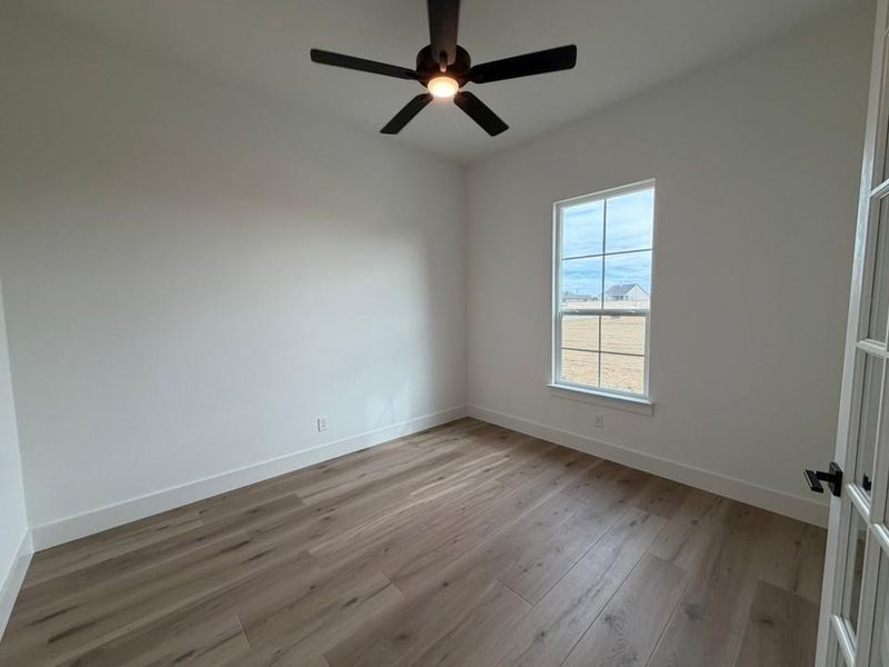 Spare room featuring light wood finished floors and a ceiling fan