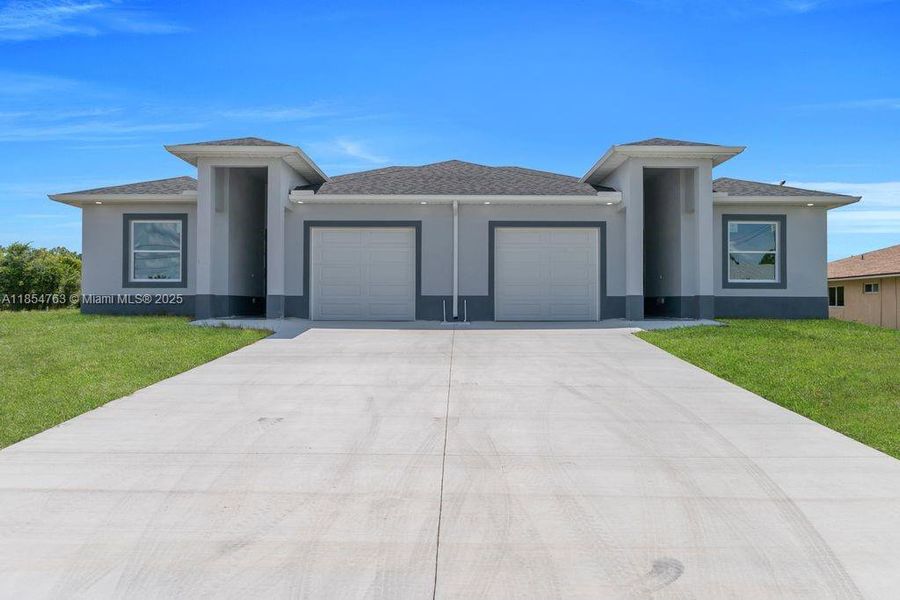 Front exterior of a new home in , Lehigh Acres, FL, highlighting curb appeal (Image 30).