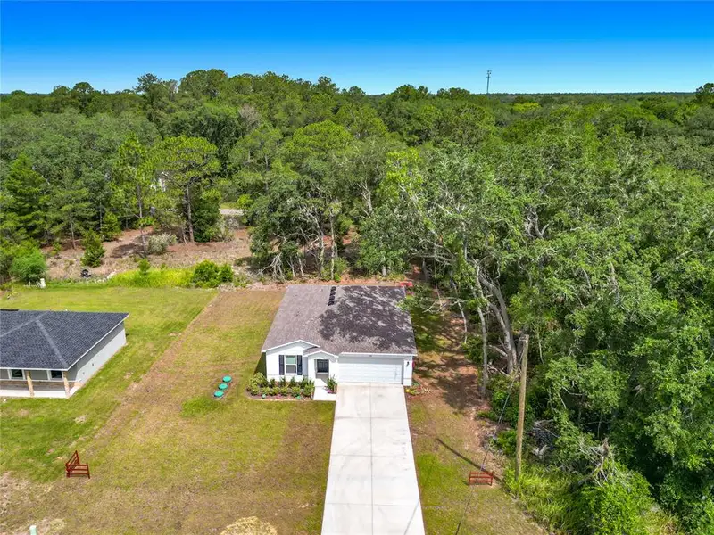 Front exterior of a new home in The Collection at Ocklawaha, Ocklawaha, FL, highlighting curb appeal (Image 24). Front exterior of a new home in The Collection at Ocklawaha, Ocklawaha, FL, highlighting curb appeal (Image 24).