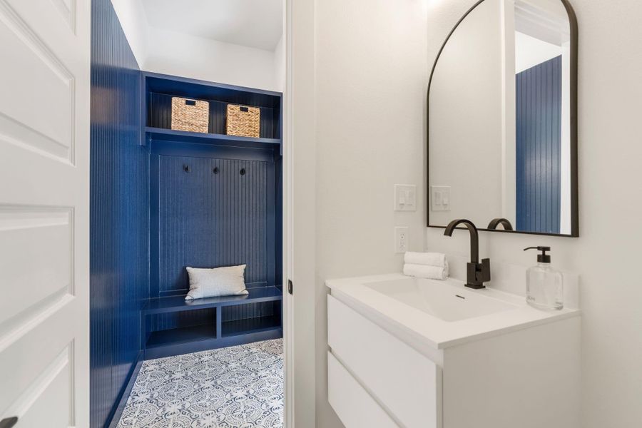 A stylish half bath and convenient mudroom complete the second floor.