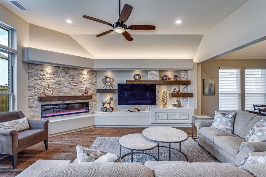 Custom media wall with ledger stone, shelves, lighting and eletric fireplace