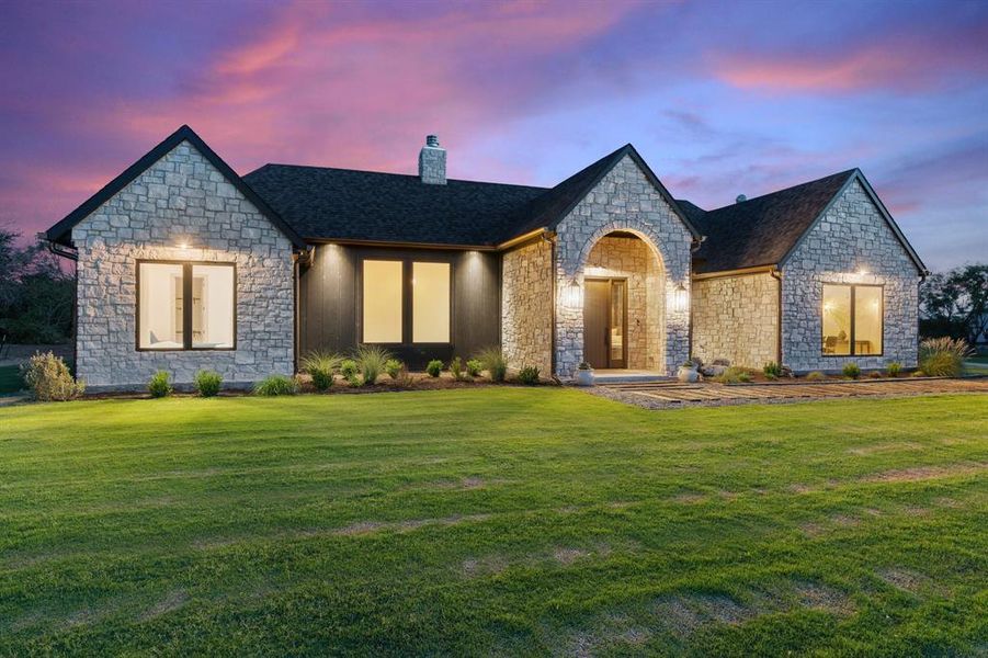 French country style house featuring a lawn