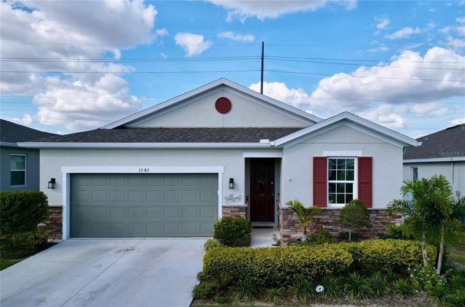 Front exterior of a new home in Seasons at Heritage Square, Haines City, FL, highlighting curb appeal (Image 32). Front exterior of a new home in Seasons at Heritage Square, Haines City, FL, highlighting curb appeal (Image 32).