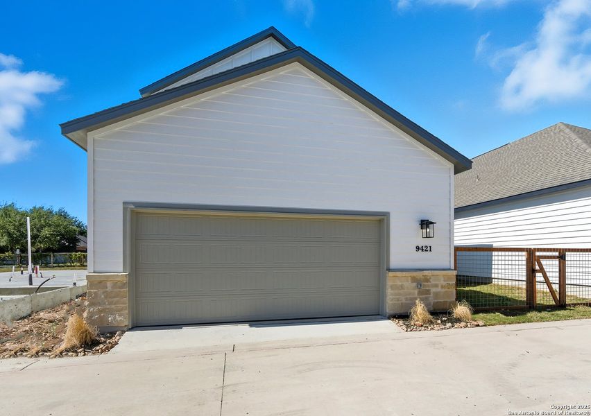 Front exterior of a new home in The Crossvine – Garden Homes, Schertz, TX, highlighting curb appeal (Image 1).