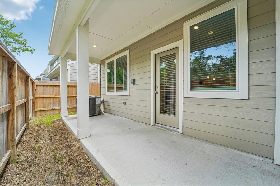 Exterior details and patio area of a home in Pinewood Trails - City Series, Atascocita (Image 26).