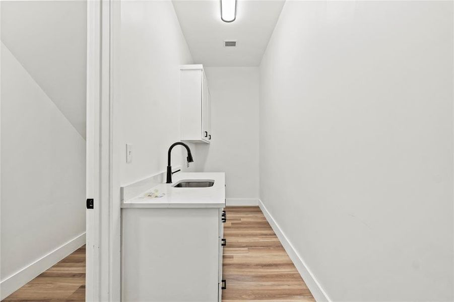 Washroom with light wood-type flooring