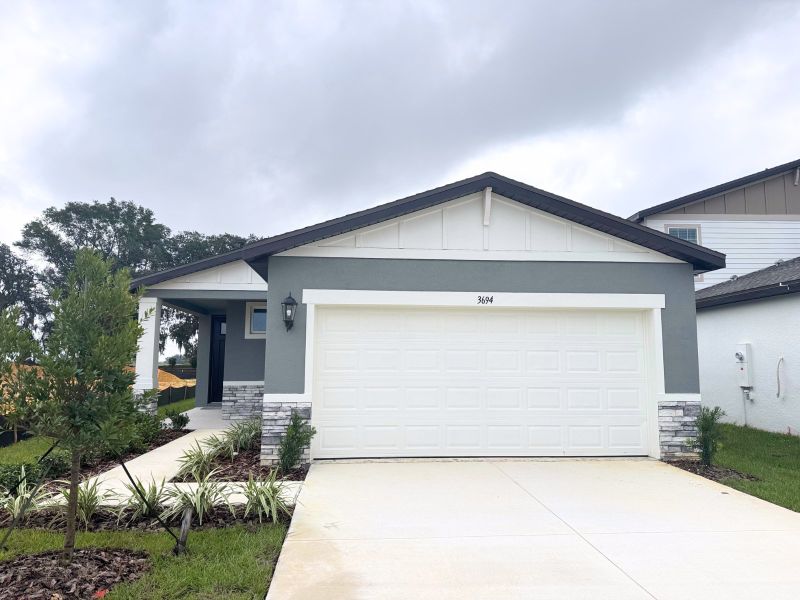 Front exterior of a new home in Benton Hills - Premier Series, Brooksville, FL, highlighting curb appeal (Image 1).