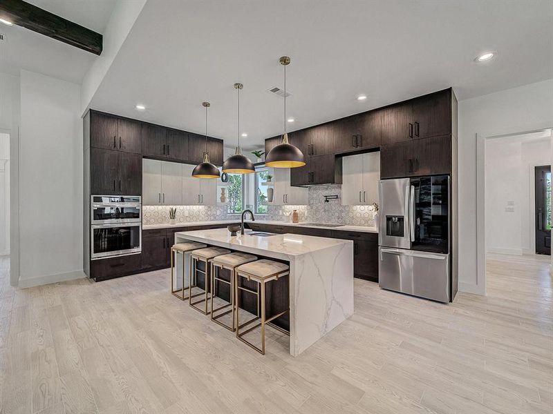 Kitchen with stainless steel appliances, tasteful backsplash, light wood-style flooring, and recessed lighting
