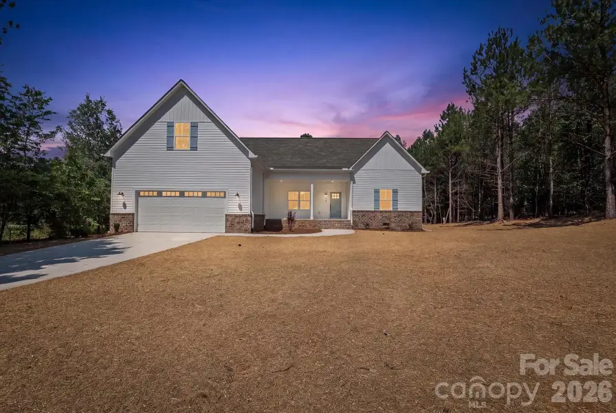 Front exterior of a new home in , Troutman, NC, highlighting curb appeal (Image 16).