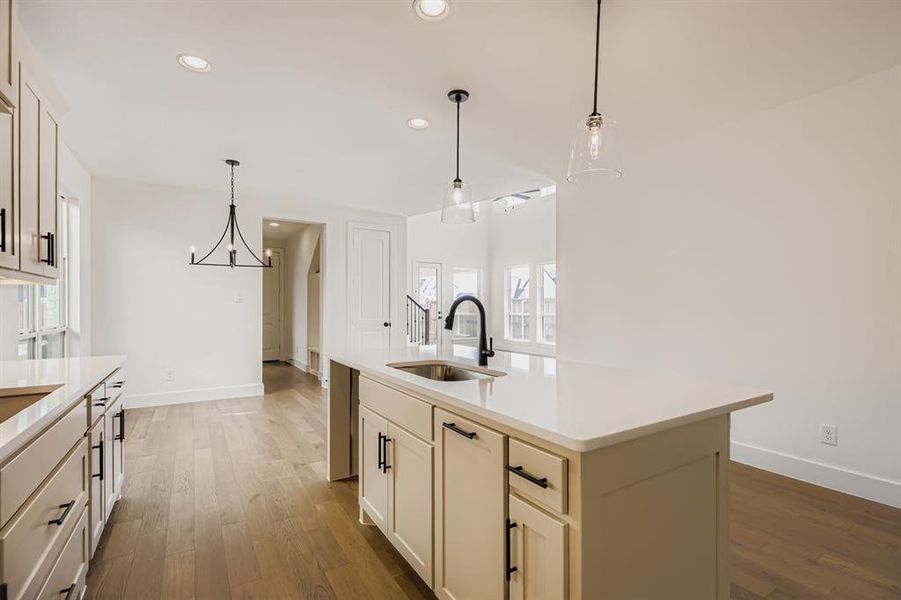 Kitchen with pendant lighting, light wood-style floors, recessed lighting, and an island with sink Kitchen with pendant lighting, light wood-style floors, recessed lighting, and an island with sink