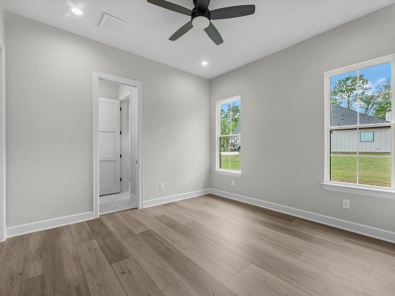 Light-filled secondary bedroom with neutral tones and modern finishes.