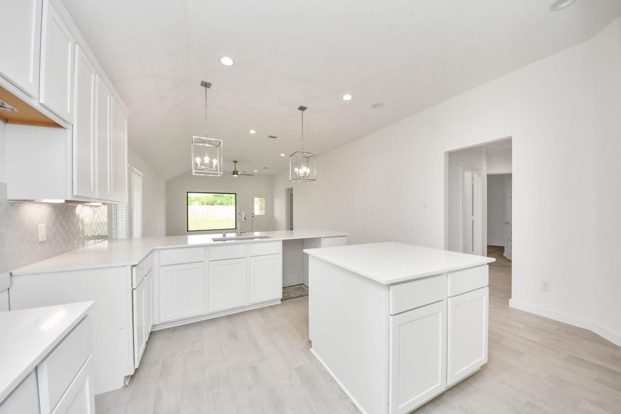 The open concept effortlessly connects the kitchen to the expansive family room, forming a perfect hub for gatherings. This seamless flow creates an inviting space where cooking and socializing come together harmoniously. Sample photo of completed home with similar floor plan. Actual colors and selections may vary. The open concept effortlessly connects the kitchen to the expansive family room, forming a perfect hub for gatherings. This seamless flow creates an inviting space where cooking and socializing come together harmoniously. Sample photo of completed home with similar floor plan. Actual colors and selections may vary.