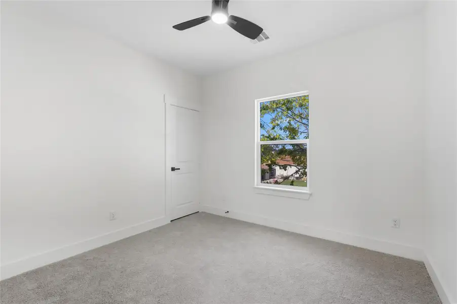 Bedroom three is a perfect black canvas filled with natural light and soft carpeting, offering a cozy space. With its clean design and modern ceiling fan, its ready to fit your needs!