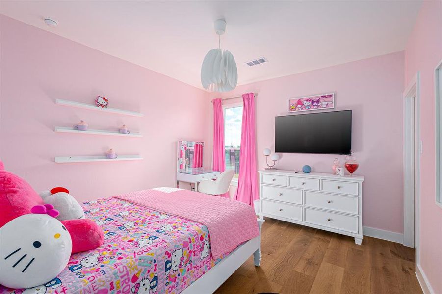 Bedroom featuring light wood-type flooring and baseboards