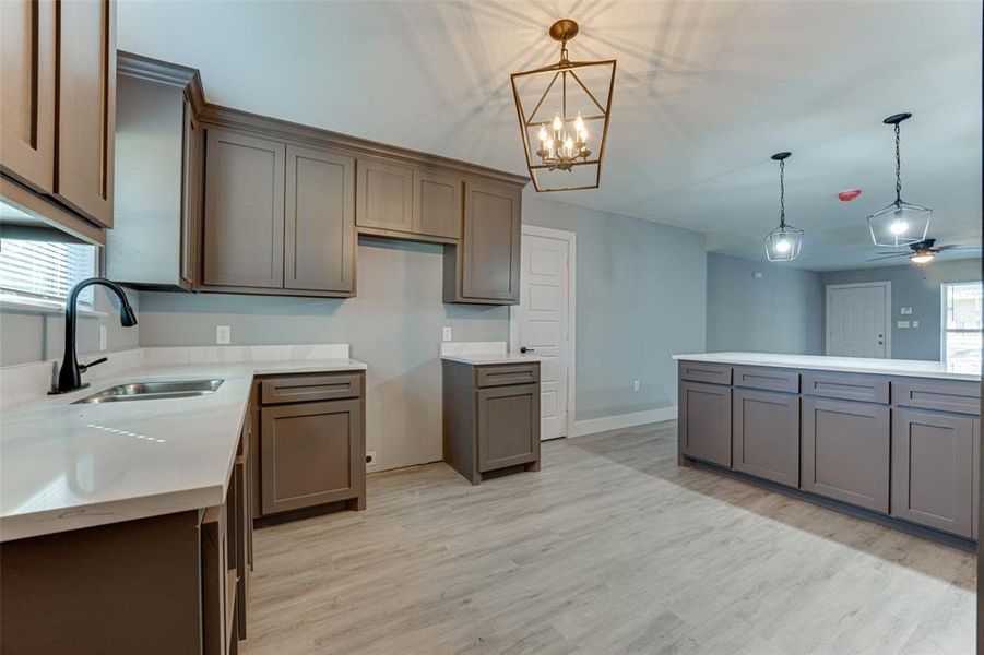 Kitchen with plenty of natural light, sink, and pendant lighting