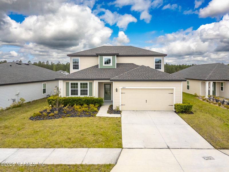 Front exterior of a new home in Westport Landing, Jacksonville, FL, highlighting curb appeal (Image 24).