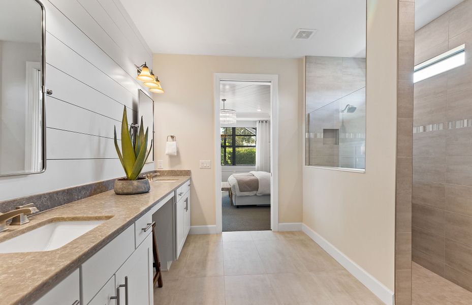 Owner's bathroom with dual sink vanity and walk-in shower