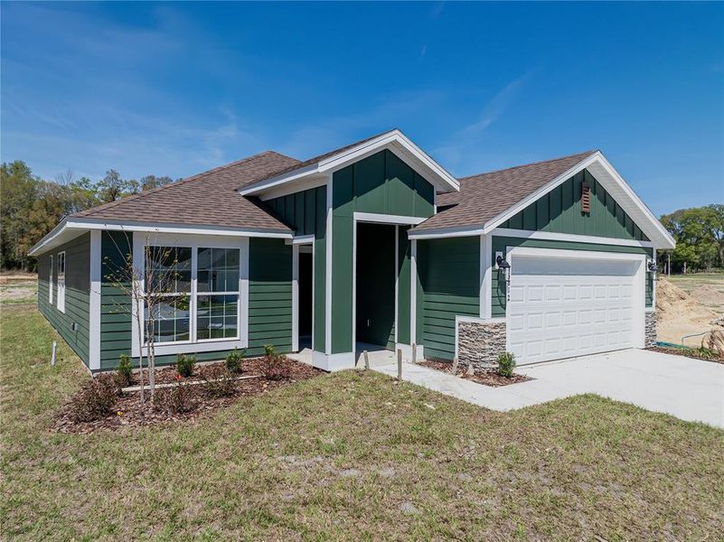 Front exterior of a new home in Briarwood, Alachua, FL, highlighting curb appeal (Image 18).