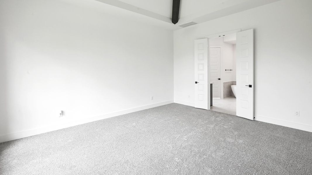 Unfurnished bedroom featuring carpet flooring and beamed ceiling Unfurnished bedroom featuring carpet flooring and beamed ceiling