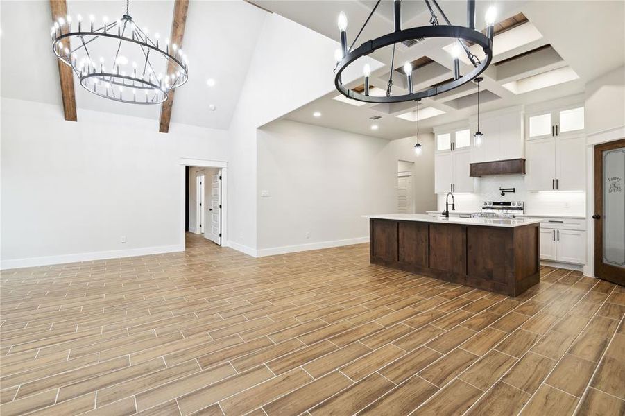 Kitchen featuring white cabinetry, hanging light fixtures, and a chandelier