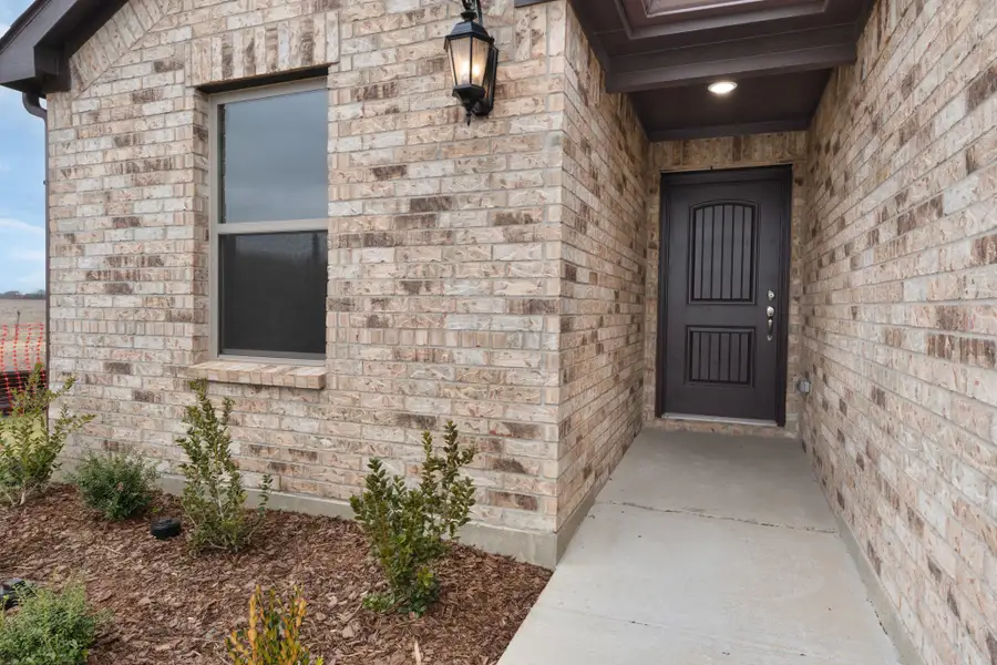 Exterior details and patio area of a home in Stonecreek, Sulphur Springs (Image 3).