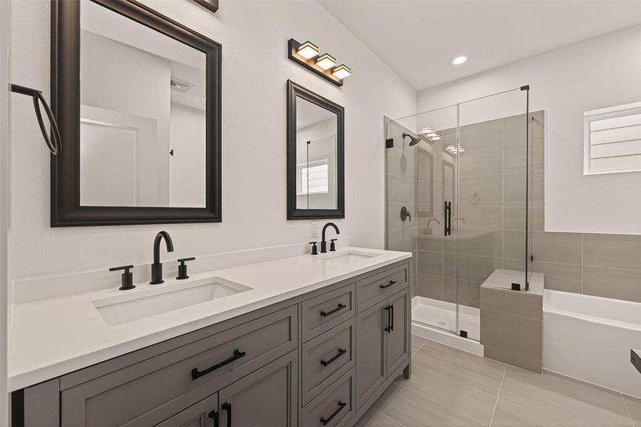 This modern bathroom features a sleek double vanity with dark fixtures, large mirrors, and a glass-enclosed shower. The neutral tones and clean lines create a sophisticated and inviting atmosphere. This modern bathroom features a sleek double vanity with dark fixtures, large mirrors, and a glass-enclosed shower. The neutral tones and clean lines create a sophisticated and inviting atmosphere.