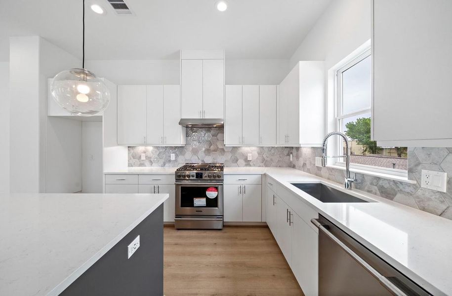 Quartz countertops, designer tile, and soft-close shaker-style cabinets are hallmark features of Riverway Homes in Somerset Green.Photos depict a completed Riverway Home; this home is under construction and finishes may vary.