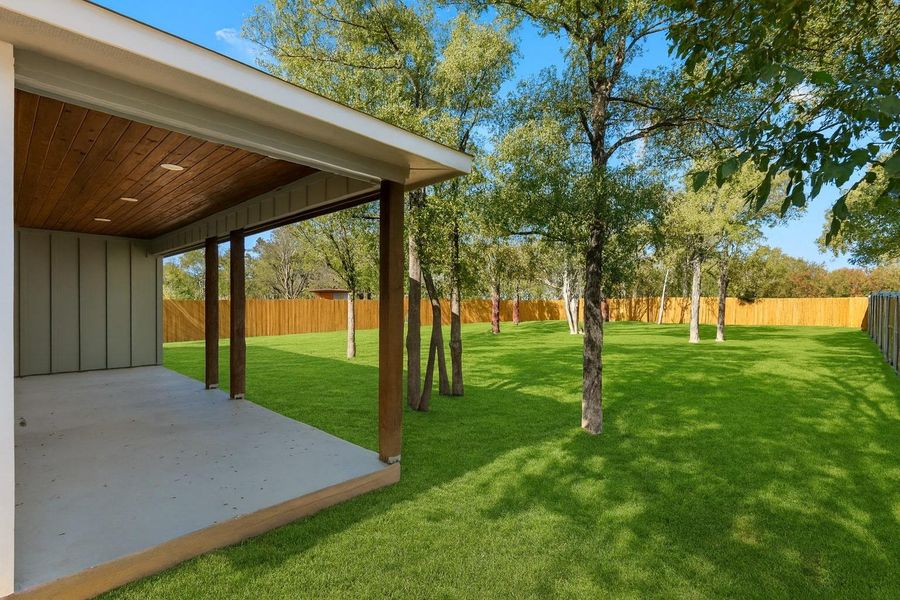 Virtually modified Fenced backyard featuring a patio