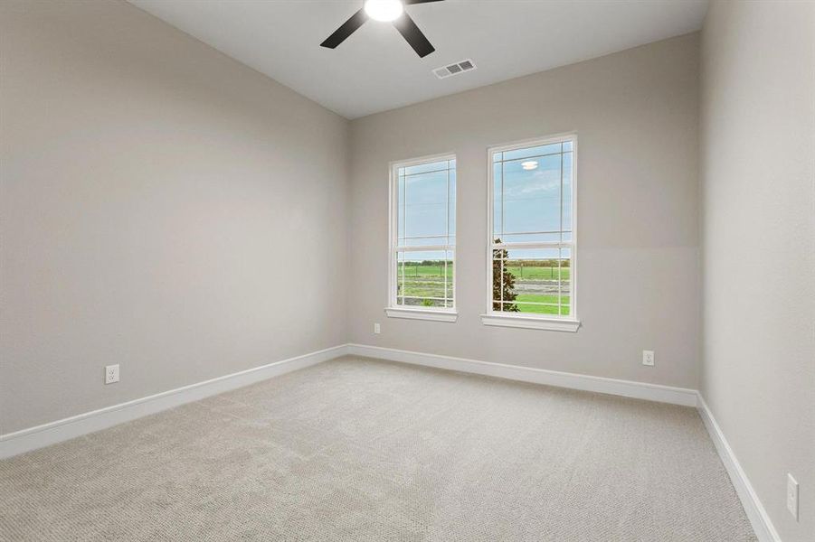 Empty room featuring light carpet and ceiling fan