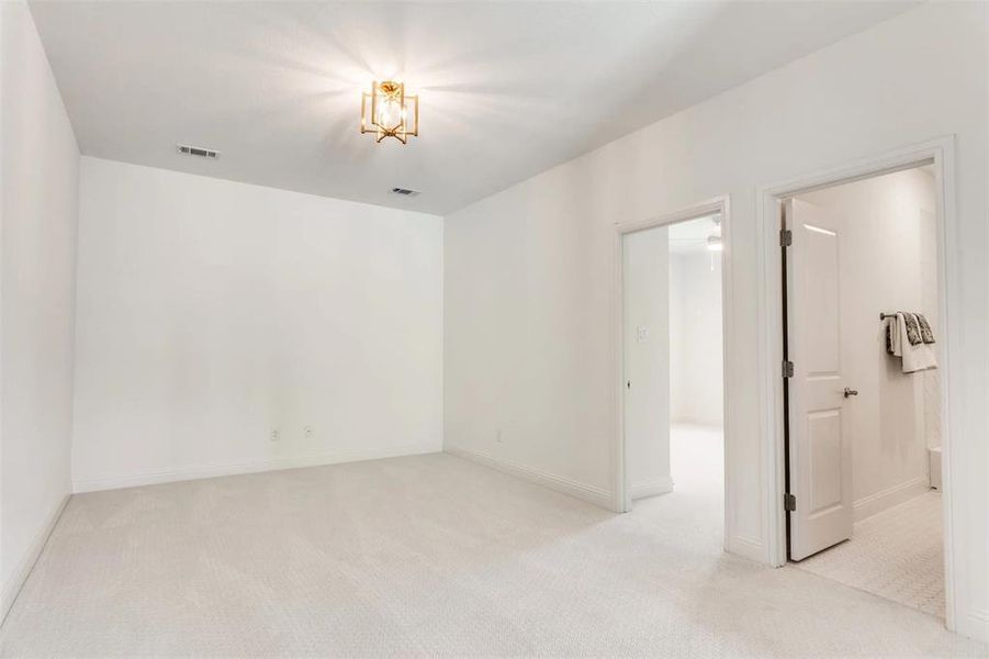 Spare room with light carpet and baseboards