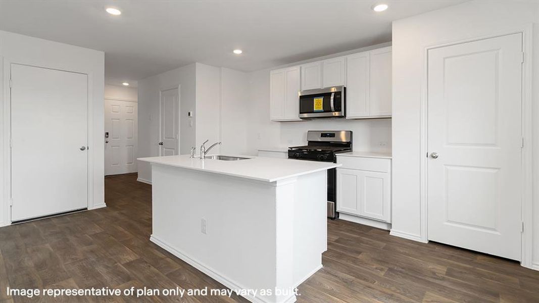 Kitchen with appliances with stainless steel finishes, white cabinets, recessed lighting, a center island with sink, and dark wood-style flooring